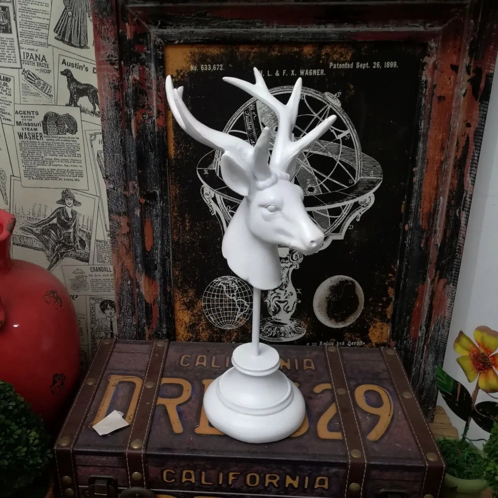 Tall black natural resin animal sculpture for home decoration on a wooden table.