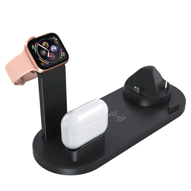 Black three-in-one wireless charging station holding an Apple Watch, AirPods case, and an iPhone on a desk.