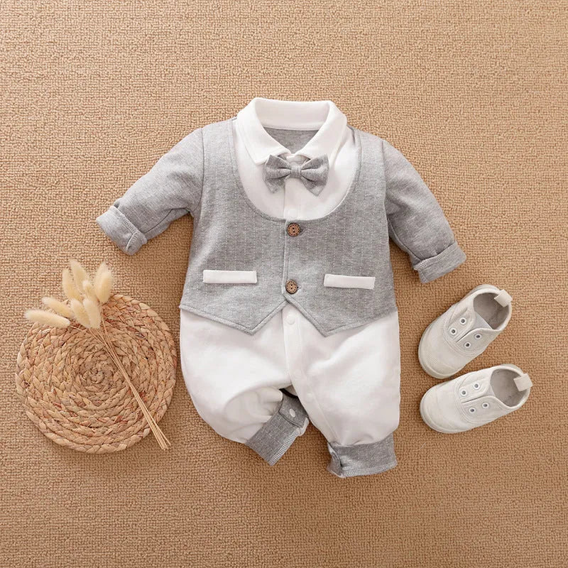 Baby boy wearing cotton gentleman-style jumpsuit in navy blue with long sleeves for spring or autumn