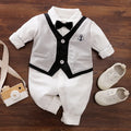 Baby boy wearing cotton gentleman-style jumpsuit in navy blue with long sleeves for spring or autumn