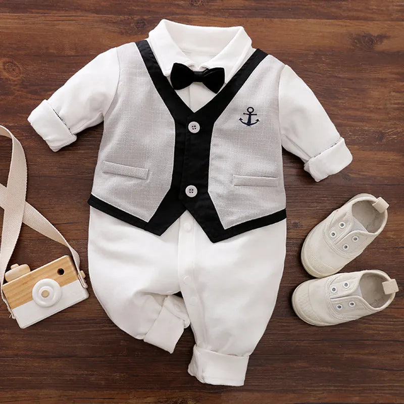 Baby boy wearing cotton gentleman-style jumpsuit in navy blue with long sleeves for spring or autumn