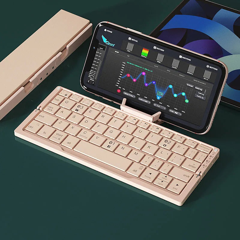 Silver white aluminium folding Bluetooth keyboard open with smartphone propped on hidden stand