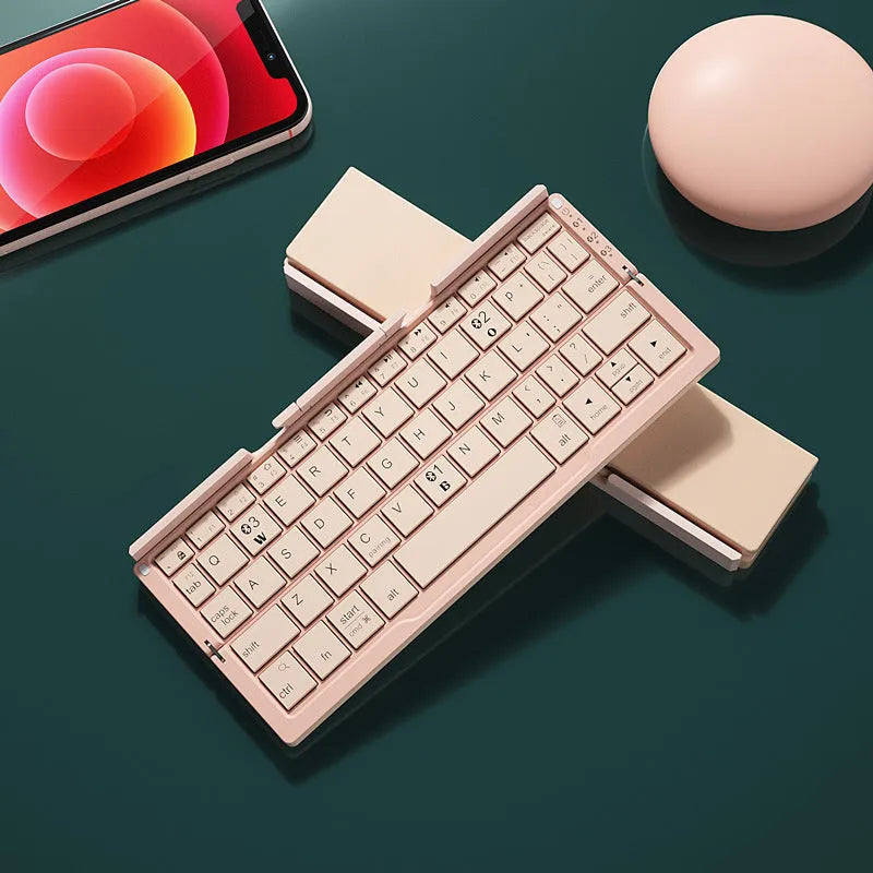 Silver white aluminium folding Bluetooth keyboard open with smartphone propped on hidden stand