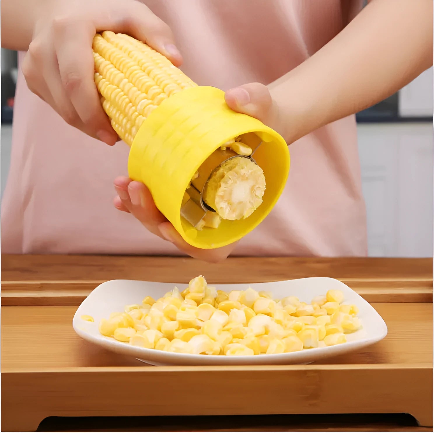 Yellow manual corn grinder thresher with corn-shaped design and PP plastic grip.