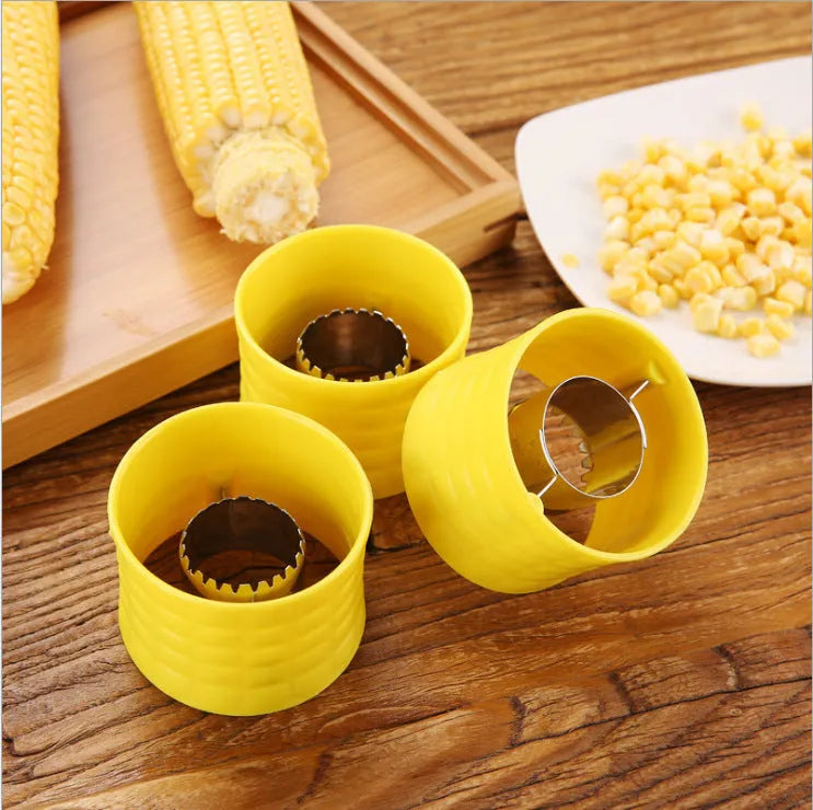 Yellow manual corn grinder thresher with corn-shaped design and PP plastic grip.