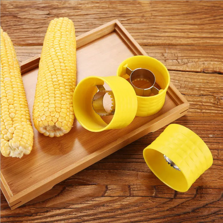 Yellow manual corn grinder thresher with corn-shaped design and PP plastic grip.