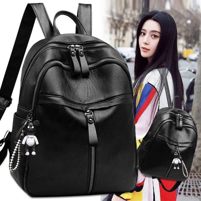 Medium black PU leather backpack with double straps showing plain pattern design