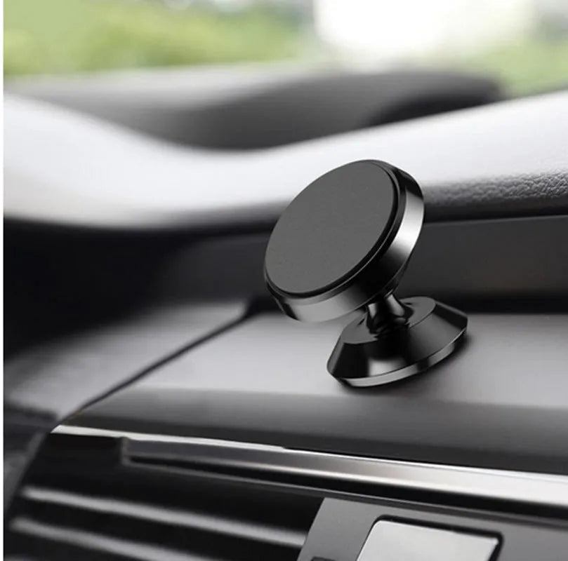 Magnetic car air outlet phone bracket in black attached to a vehicle vent