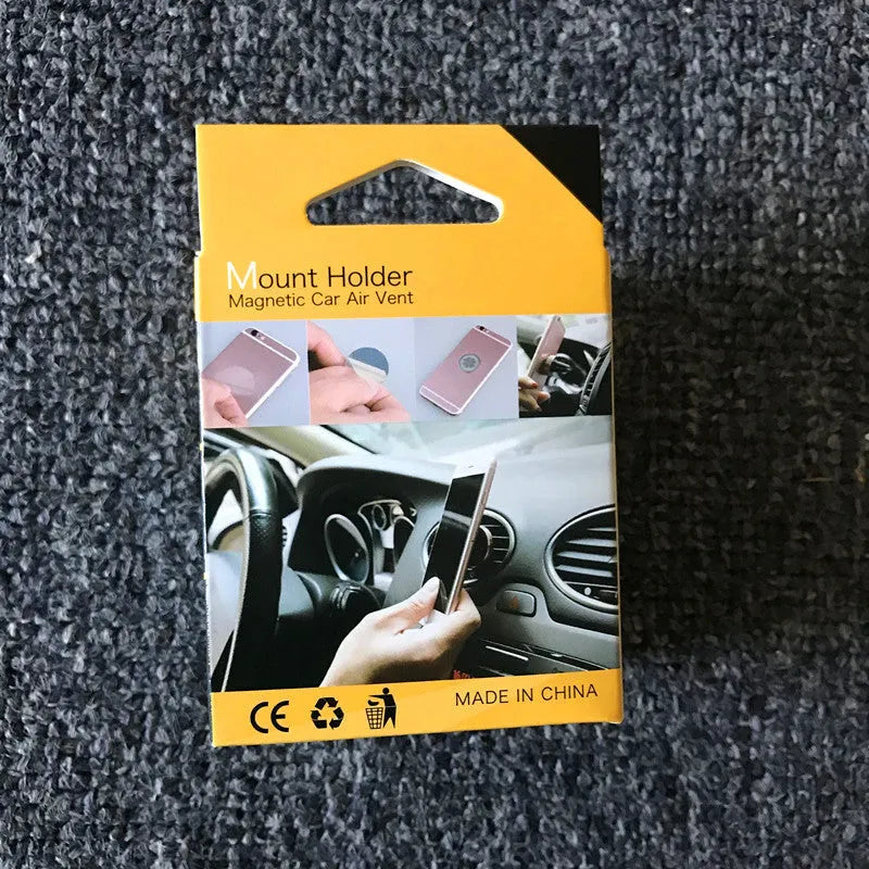 Magnetic car air outlet phone bracket in black attached to a vehicle vent