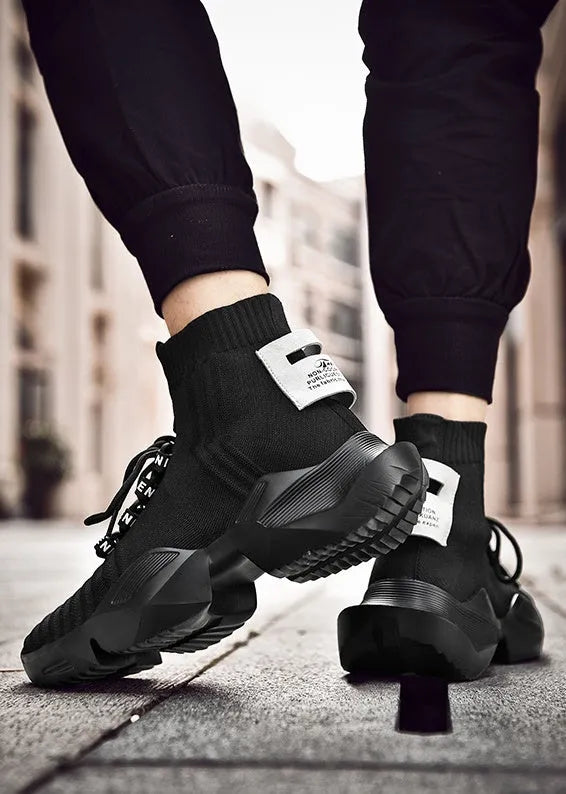 Men's black and white casual sports shoes showing mesh lining and adhesive construction