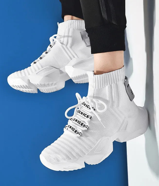 Men's black and white casual sports shoes showing mesh lining and adhesive construction
