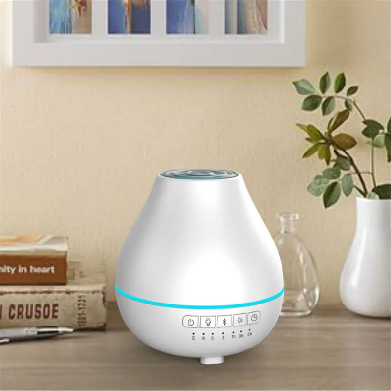 Round white Bluetooth humidifier and aroma diffuser with night light on a surface.