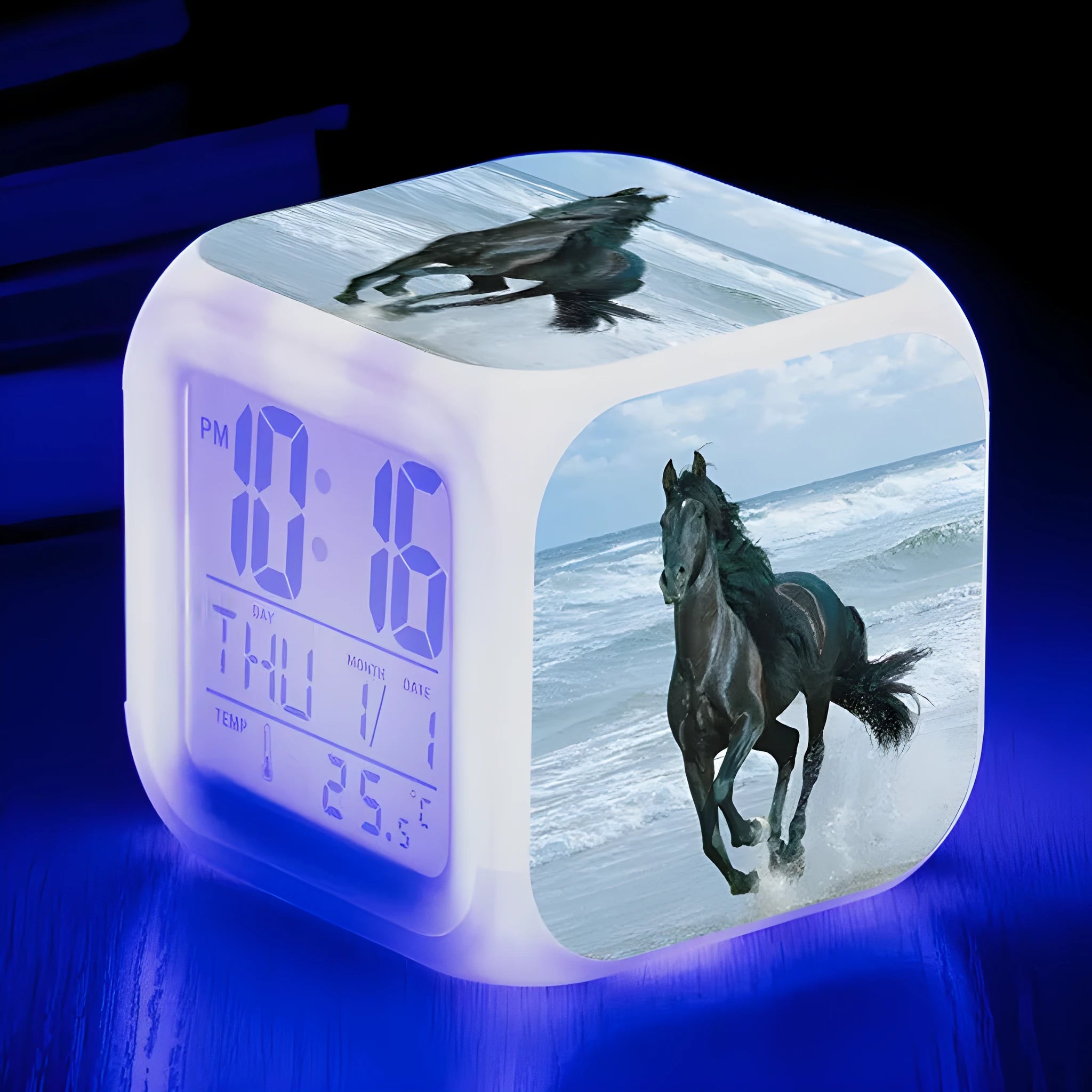 Small square cartoon-style LED alarm clock showing time and temperature, in one of 15 available colour variants.
