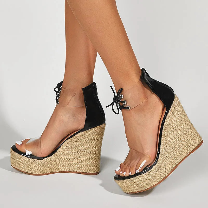 Black women's wedge sandals with hemp rope detail and a high platform sole on a white background.