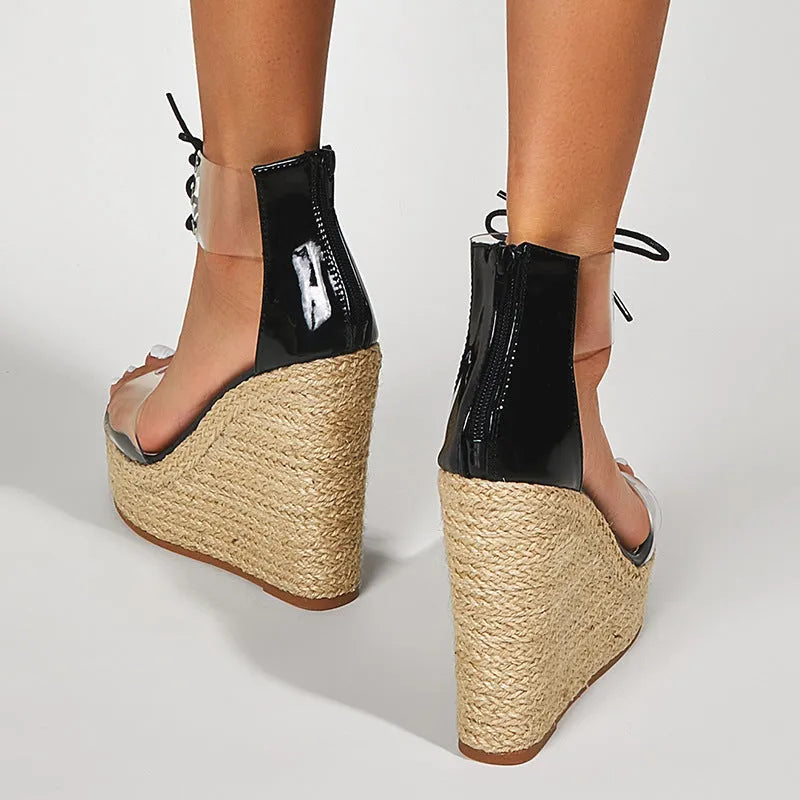 Black women's wedge sandals with hemp rope detail and a high platform sole on a white background.