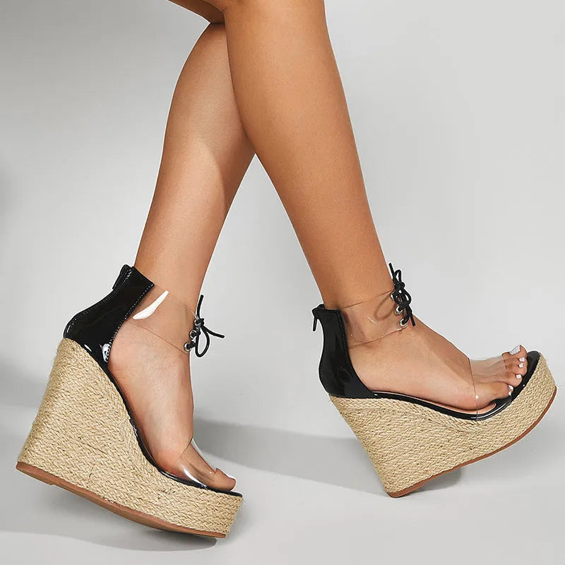 Black women's wedge sandals with hemp rope detail and a high platform sole on a white background.