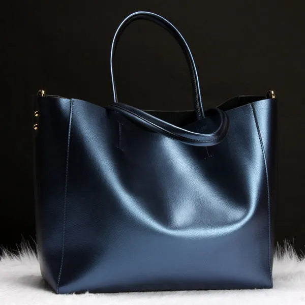 Women's cowhide leather shoulder bag showing silver, bronze, wine red, blue, and black colour options