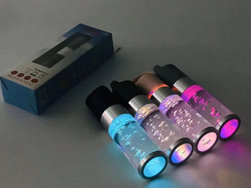 Pink portable Bluetooth speaker with colourful cartoon crystal LED lights on display.