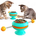 Rotatable cat toy with turntable, three catnip balls, and suction cup base in lake blue colour