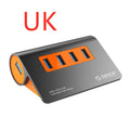 Dark grey aluminium USB-C hub with four USB 3.1 ports, orange trim, external power input, and a separate cable.