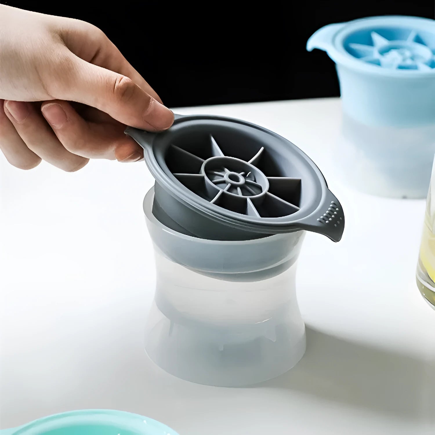 Silicone ice tray showing large ice hockey shape and round ice moulds in assorted colours
