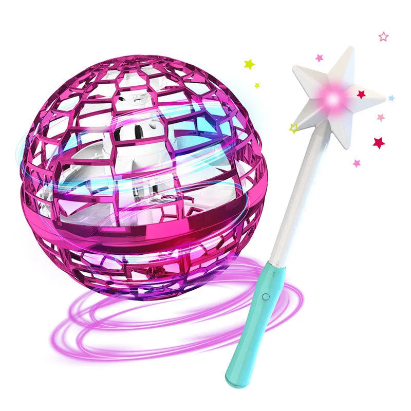 Blue spinning flying ball toy with LED lights hovering above a child's hand next to a magic wand.