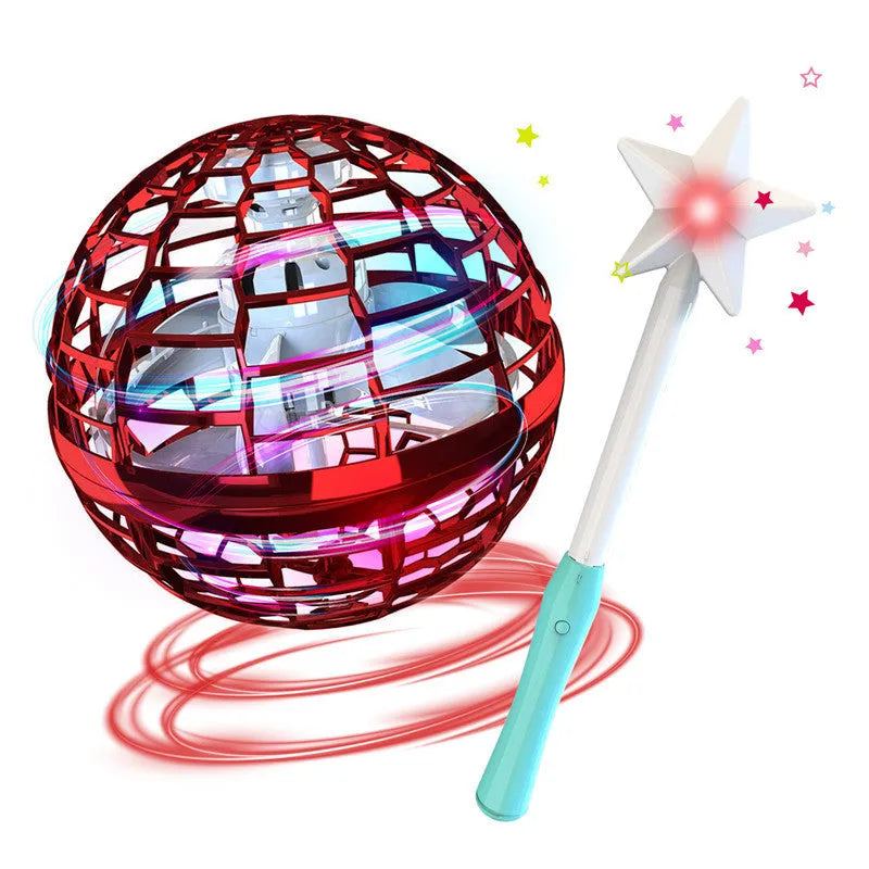 Blue spinning flying ball toy with LED lights hovering above a child's hand next to a magic wand.
