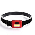 Compact black, blue, or red outdoor LED headlamp with adjustable strap on a grey background
