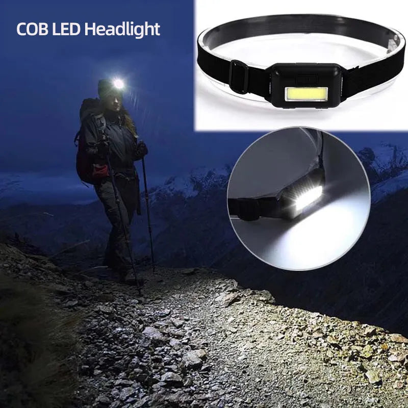 Compact black, blue, or red outdoor LED headlamp with adjustable strap on a grey background
