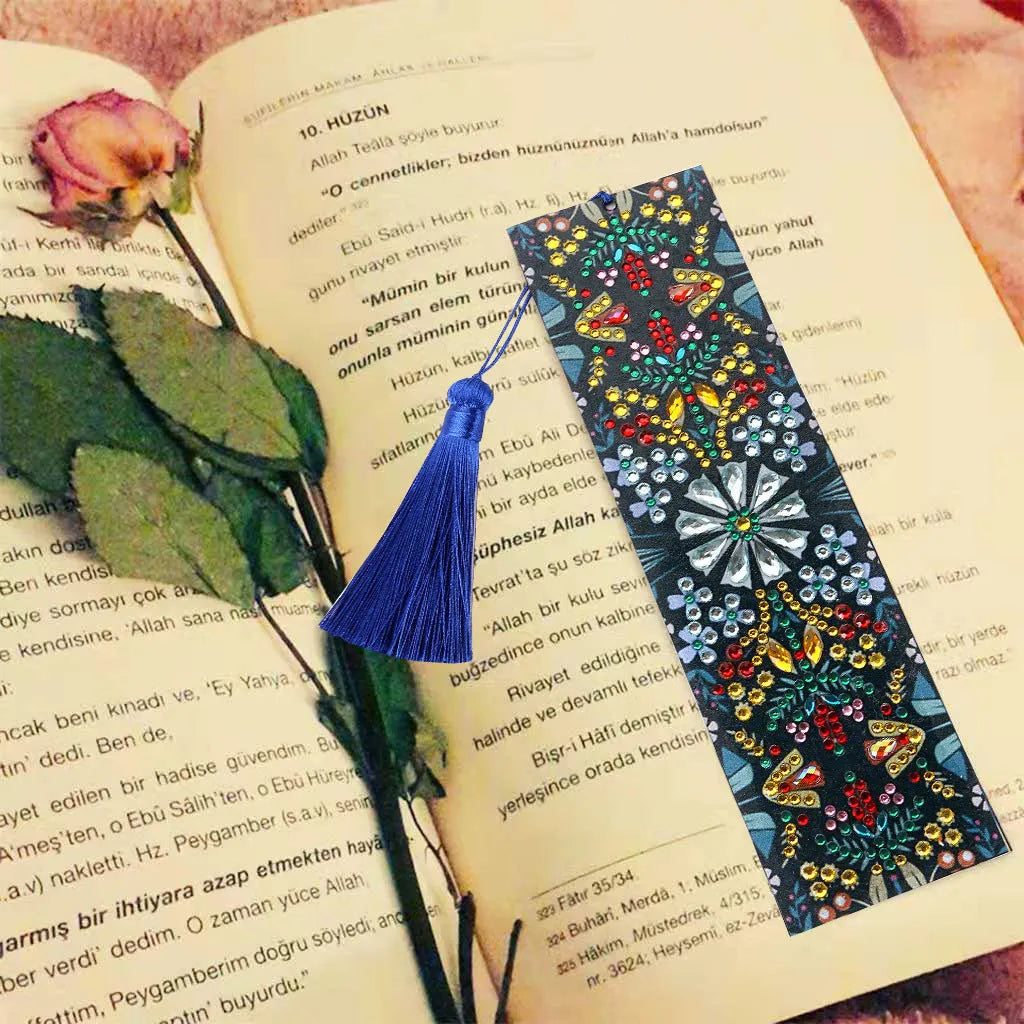Handcrafted leather bookmark with a diamond-embroidered mandala flower design.