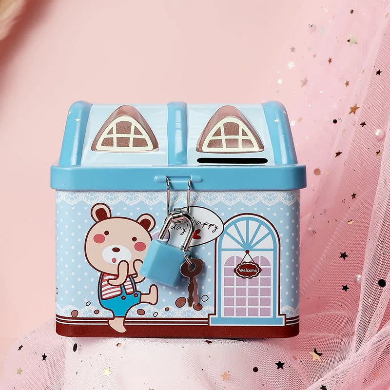 Blue house-shaped tinplate piggy bank for coin saving on wooden desk