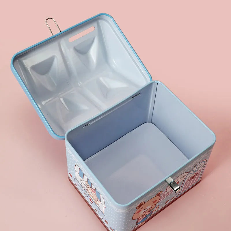 Blue house-shaped tinplate piggy bank for coin saving on wooden desk