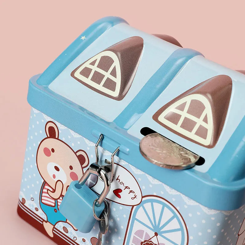 Blue house-shaped tinplate piggy bank for coin saving on wooden desk