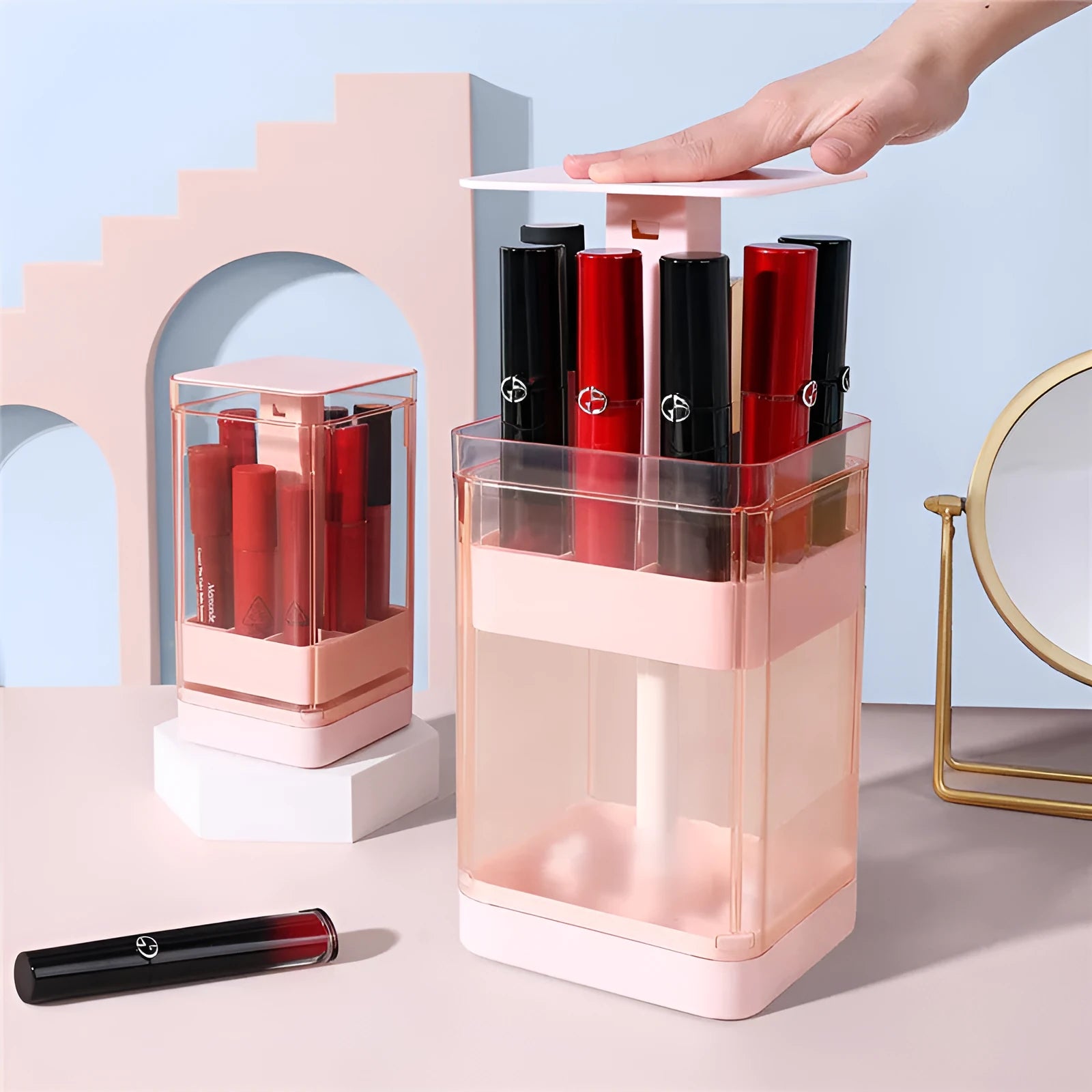 Press lift lipstick storage organiser box in pink colour showing internal grid compartments for cosmetics.