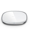 Black wireless phone charger with glass surface showing charging indicator light