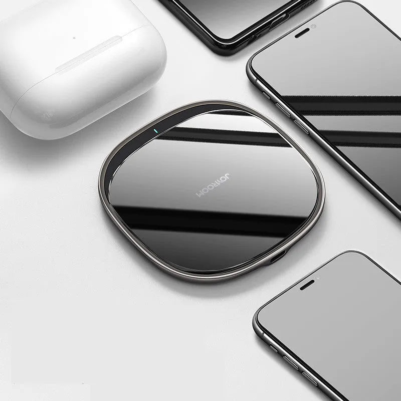 Black wireless phone charger with glass surface showing charging indicator light