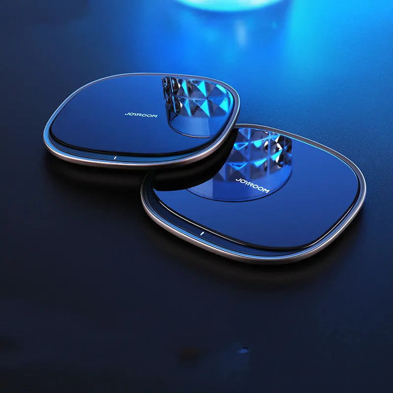Black wireless phone charger with glass surface showing charging indicator light
