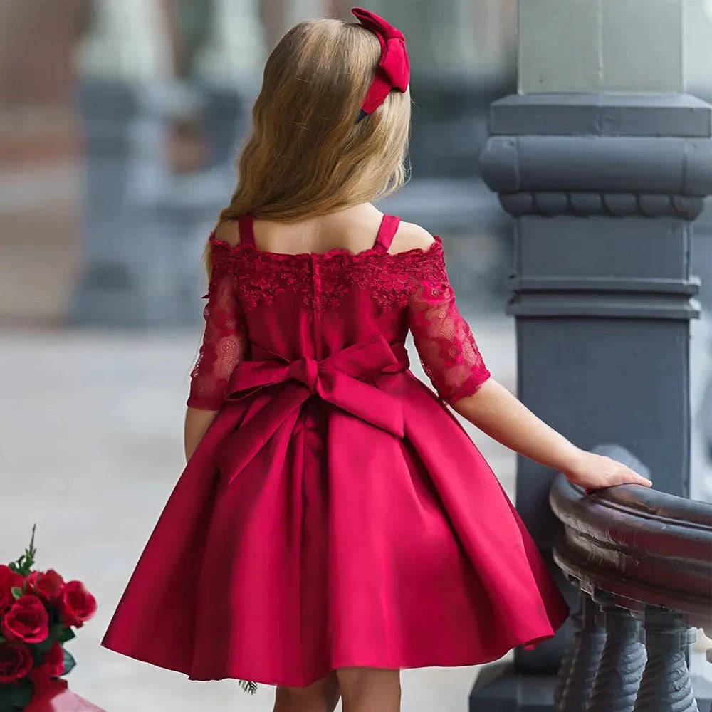 Simple girls' lace-trimmed dress in polyester, shown in red, on a hanger.