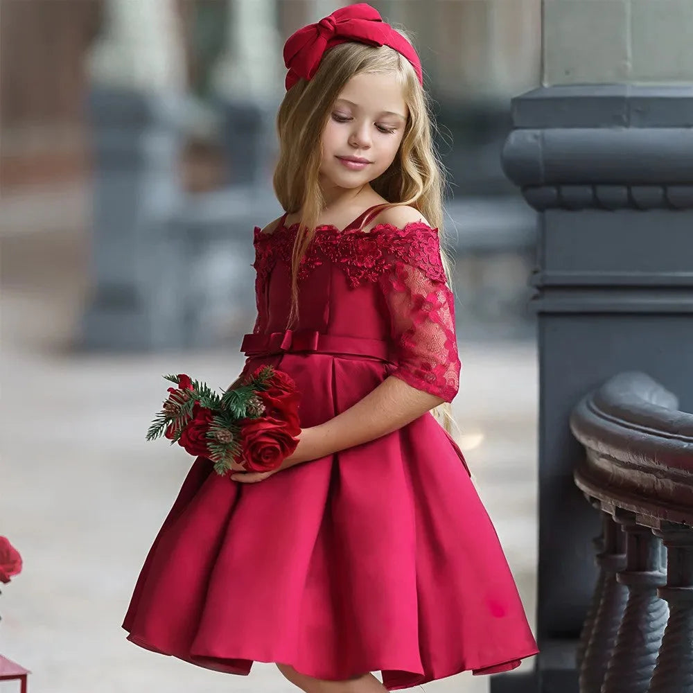 Simple girls' lace-trimmed dress in polyester, shown in red, on a hanger.