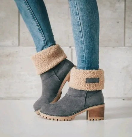 Women's black suede mid-tube knight snow boots with a thick sole and low flat heel on a plain background.