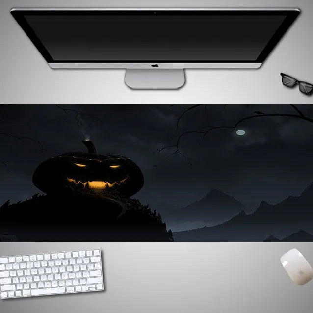 Oversized Halloween-themed computer mouse pad with non-slip rubber cloth base on a desk