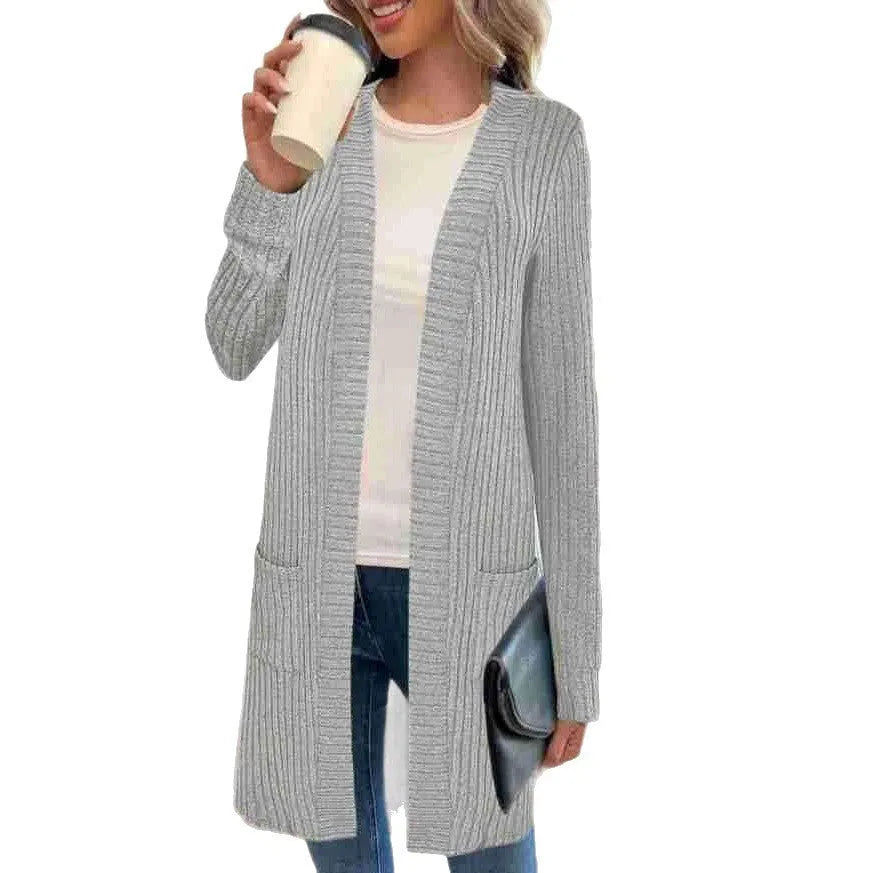Long sleeve loose fit knitted cardigan jacket in black, shown with two front pockets.