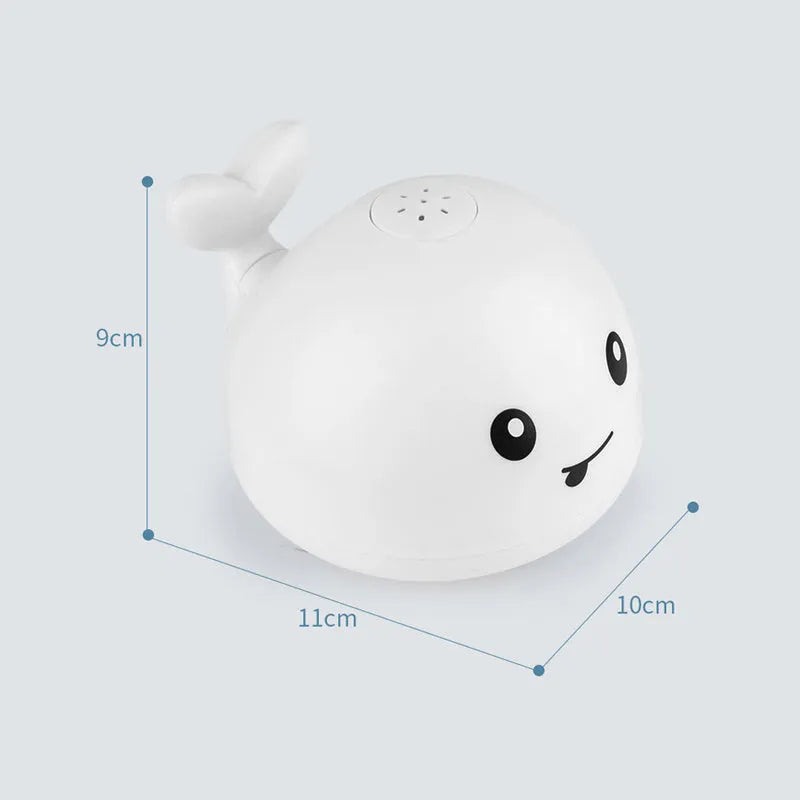 White and blue whale-shaped bath toy with water spray and LED lights floating in water