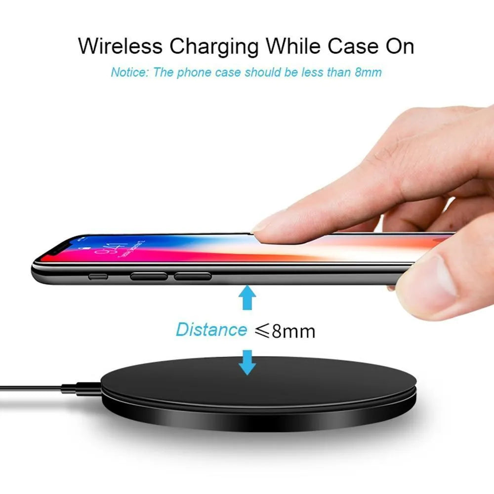 Black ultra-thin square wireless fast charging pad with USB cable on a desk