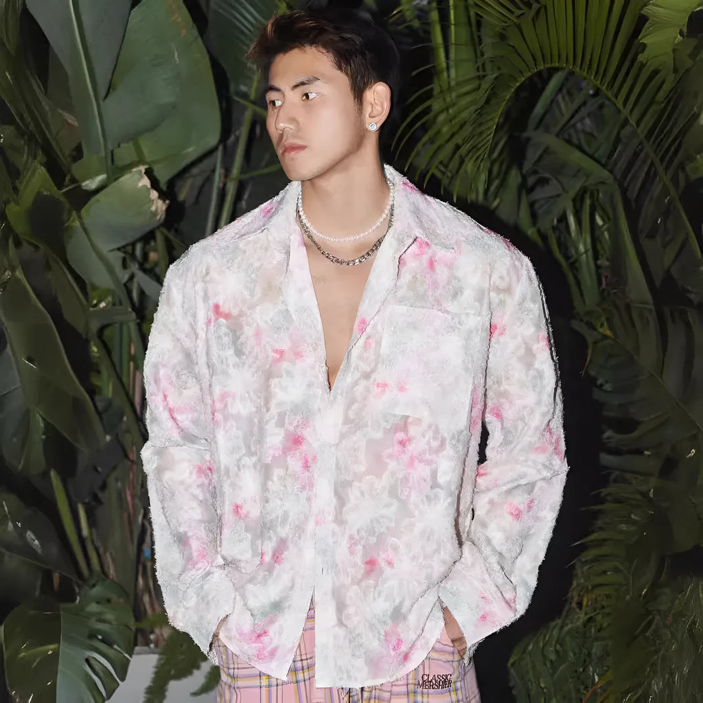 Man wearing a blue loose-fit long sleeve shirt with an embossed three-dimensional floral pattern.