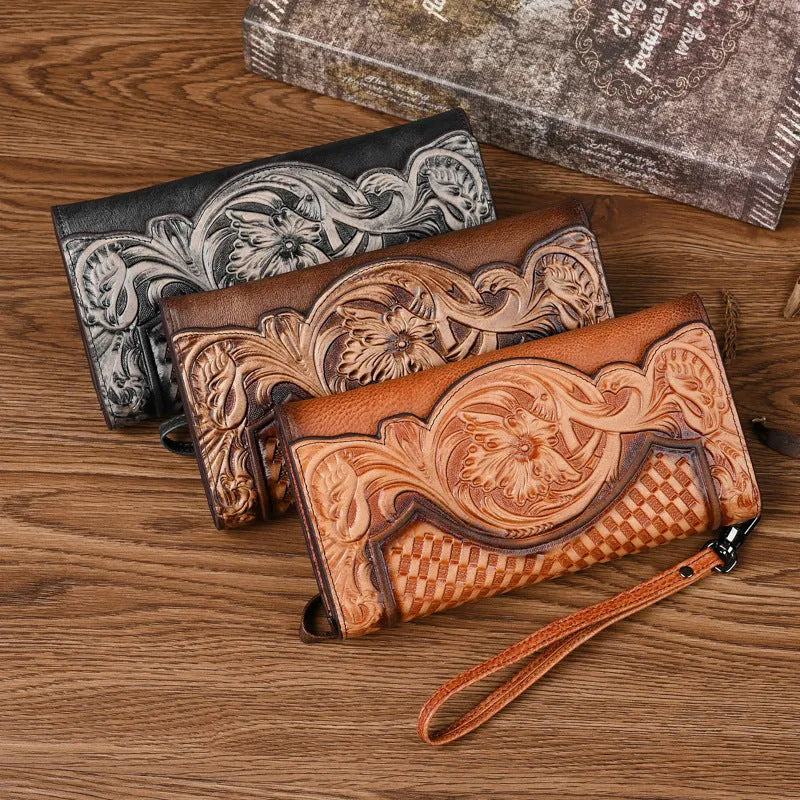 Brown genuine leather tri-fold wallet with embossed floral pattern, shown open to display compartments.