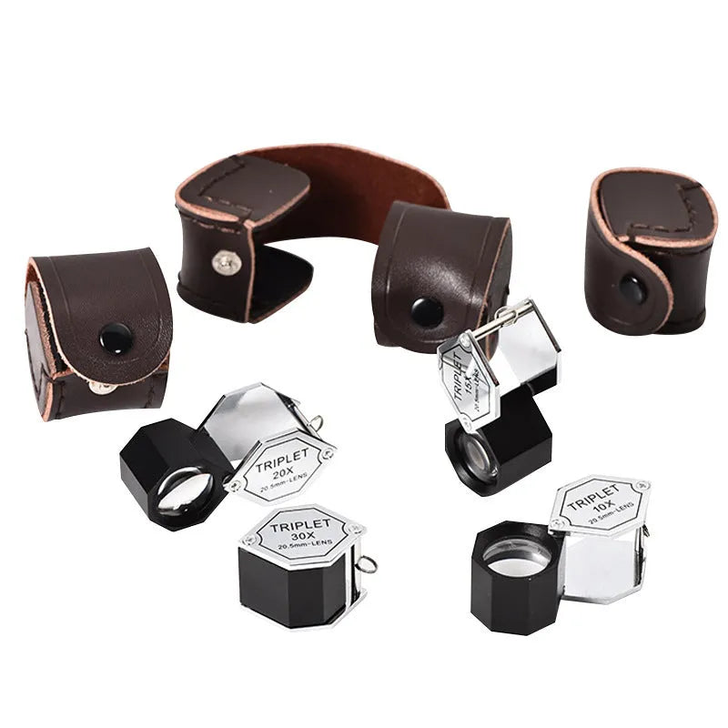 Handheld metal magnifying glass with optical lens for jewellery and stamp identification.