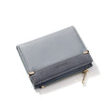 Black ladies folding wallet with a short zip, open to show multiple card slots, bill holder, and change compartment.