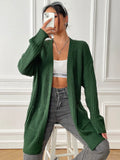 Women's loose acrylic cardigan with two pockets in dark green colour, mid-length design