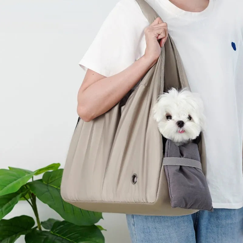 Apricot coloured cloth pet handbag for outdoor summer use.